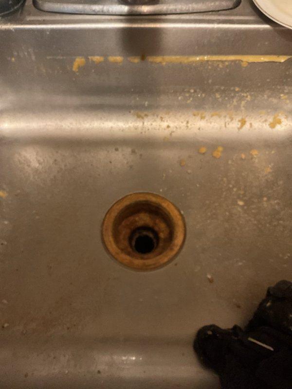 Responded to a kitchen sink drain obstruction caused by a broken strainer and utensil lodged in the drain line. Accessed the main drain cleanout, removed the broken strainer component and fork from the line, and cleared the standing water backup. Verified proper drainage flow through the P-trap assembly and restored full functionality to the kitchen sink drain system.