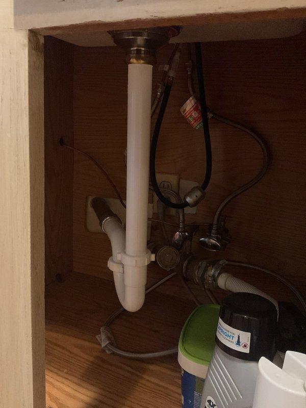 Responded to a kitchen sink drain obstruction caused by a broken strainer and utensil lodged in the drain line. Accessed the main drain cleanout, removed the broken strainer component and fork from the line, and cleared the standing water backup. Verified proper drainage flow through the P-trap assembly and restored full functionality to the kitchen sink drain system.