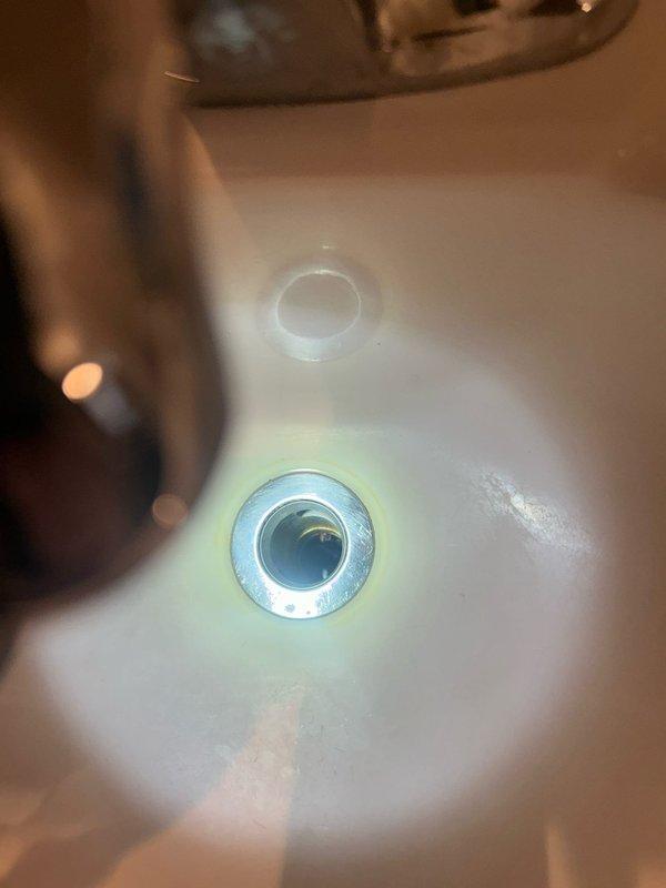 Responded to multiple plumbing issues including assessment of leaking tub spout fixtures, evaluation for new shower head and handheld shower head installations across multiple units, and inspection of outdoor spigot installation requirements. Additionally addressed a leaking pipe near the water meter and diagnosed a slow-draining bathtub, documenting existing fixture conditions showing water staining and corrosion on chrome trim plates and valve assemblies.