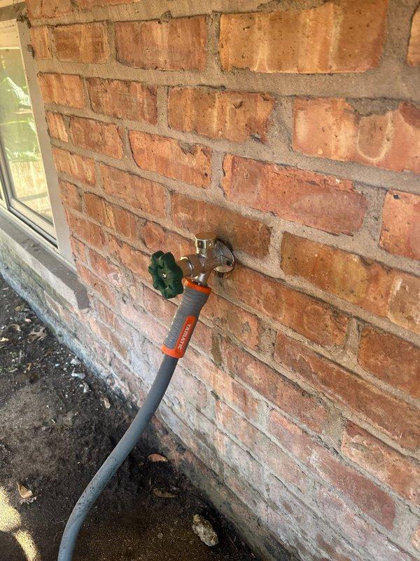 Responded to service call for leaking outdoor spigot and backed-up lavatory. Inspected exterior hose bib mounted on brick wall and identified active leak at connection point. Examined interior copper supply line routing from water heater area, including shut-off valve and associated fittings. Assessed plumbing configuration in utility room showing vertical and horizontal copper pipe runs with multiple elbow joints. Documented existing conditions of both interior supply infrastructure and exterior spigot installation for repair recommendations.