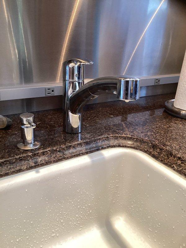 Responded to service call for loose faucet rotating at base when handle was operated. Upon inspection, found single-handle chrome faucet installed on granite countertop with undermount sink had inadequate mounting hardware tension. Tightened mounting nuts beneath countertop to manufacturer specifications, securing faucet firmly to deck. Verified proper operation with no rotation or movement during handle actuation. Tested water flow and temperature control to ensure normal function. Inspected surrounding plumbing connections for leaks and confirmed all seals intact.