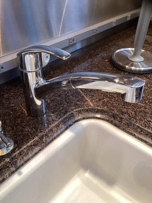 Responded to service call for loose faucet rotating at base when handle was operated. Upon inspection, found single-handle chrome faucet installed on granite countertop with undermount sink had inadequate mounting hardware tension. Tightened mounting nuts beneath countertop to manufacturer specifications, securing faucet firmly to deck. Verified proper operation with no rotation or movement during handle actuation. Tested water flow and temperature control to ensure normal function. Inspected surrounding plumbing connections for leaks and confirmed all seals intact.