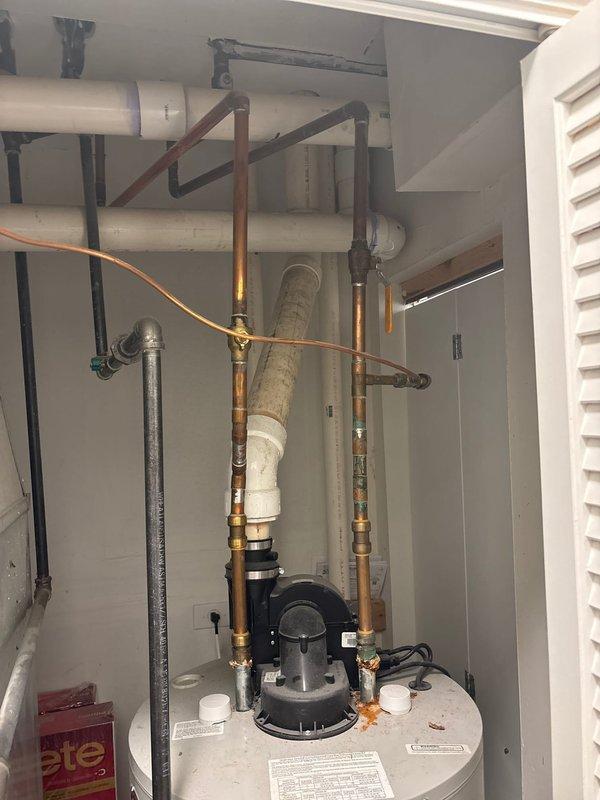 Responded to service call for bathroom vanity sink repair and water heater supply line issue. Upon inspection, assessed the undermount sink installation with chrome single-handle faucet and confirmed proper mounting and seal integrity. Examined water heater mechanical closet and inspected aged copper supply line connections showing oxidation and patina consistent with long-term use. Evaluated all plumbing connections at water heater top assembly, including vertical and angled copper runs, to identify potential leak points or deterioration requiring attention. Documented existing conditions of both fixtures for estimate preparation and recommended repairs to ensure continued safe operation of plumbing systems.