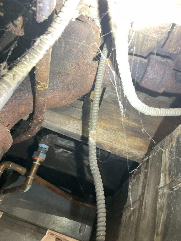 Responded to service call for clogged bathtub drain line and successfully cleared the obstruction using professional rodding equipment. Accessed drain line from crawlspace area beneath fixture, working around existing plumbing infrastructure, HVAC ductwork, and copper supply lines to restore proper drainage function.