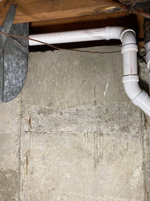 Inspected crawl space plumbing infrastructure and documented existing PVC drainage system configuration beneath structure. Evaluated condition of white PVC piping including horizontal runs and elbow connections installed along concrete foundation wall. Assessed crawl space environment noting moisture indicators on foundation surfaces and confirmed proper pipe routing through floor joist system. Repair work scheduled for completion at end of May or beginning of June per customer's request due to upcoming medical procedure.