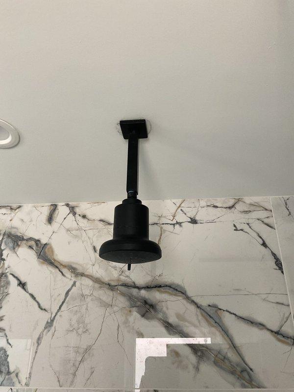Responded to service call for shower head that detached from wall in recently renovated bathroom. Upon inspection, found improper installation of shower arm with insufficient anchoring into wall structure. Removed existing shower arm and assessed wall cavity for damage. Installed proper blocking and secured new shower arm with appropriate mounting hardware to ensure secure attachment. Tested water flow and verified no leaks at connection points. Confirmed proper alignment and stability of shower head assembly before completing work.