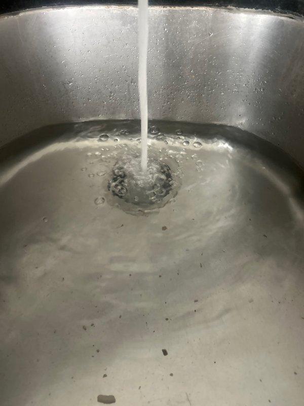 Successfully installed new kitchen faucet in undermount stainless steel sink with dark granite countertop. Addressed two existing issues with the cold water supply line: repaired dripping connection and resolved low pressure condition. Removed old faucet assembly, installed customer-provided gooseneck style chrome faucet, and ensured proper water flow and pressure to both hot and cold lines. Tested installation for leaks and verified optimal water pressure and temperature control functionality.