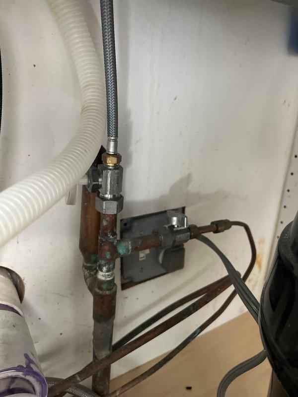 Conducted on-site assessment for installation of Aqua Sauna filtration system in residential property. Inspected existing under-sink plumbing infrastructure and utility cabinet space, documenting extensive corrosion on metal pipe fittings, rust deterioration on vertical supply lines, and verdigris buildup on copper connections. Evaluated current configuration including flexible supply hoses, shut-off valves, and electrical connections to determine compatibility requirements and necessary modifications for whole-home water treatment system integration.