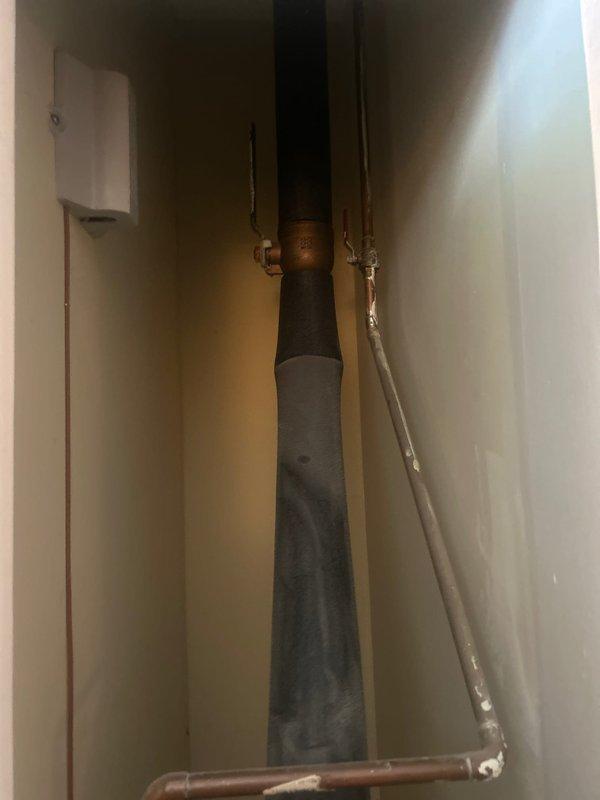 Responded to service call for leak originating from outdoor spigot entering storage unit area. Upon inspection, accessed crawl space and utility chase to locate source of water intrusion. Identified compromised piping connection at outdoor spigot supply line where it penetrated foundation wall into storage area. Traced supply plumbing through vertical chase containing existing drainage and water supply infrastructure. Assessed condition of copper supply lines, fittings, and connection points in confined utility space. Addressed leak at spigot penetration point and verified proper function of outdoor fixture. Restored water-tight integrity to prevent further moisture infiltration into storage unit.