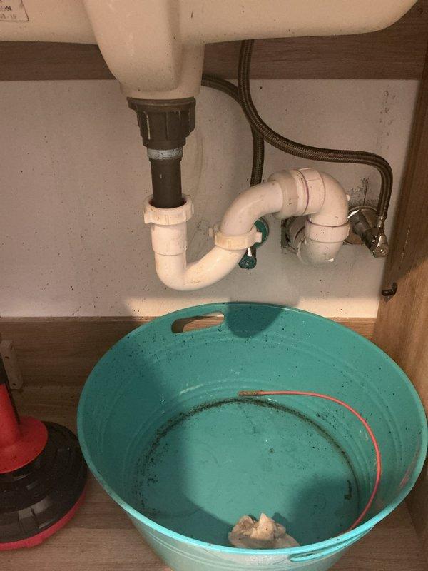 Responded to under-sink plumbing concern at bathroom vanity. Upon inspection, identified active leak in P-trap assembly beneath undermount sink. Placed collection basin to contain water during diagnosis and repair. Disassembled drain piping, replaced faulty P-trap components, and reinstalled with proper sealing. Tested water flow and verified all connections are secure with no leaks present. System restored to full functionality.