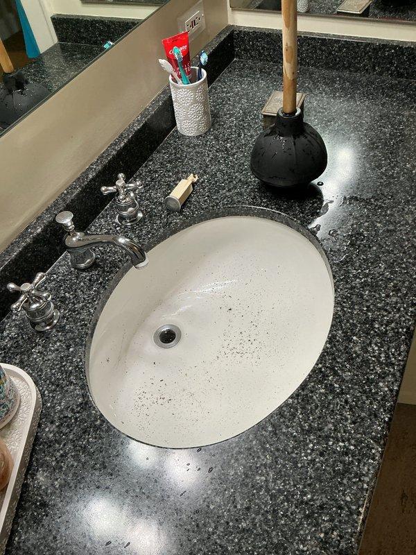 Responded to emergency plumbing call for active tub leak on upper floor of historic 1890s home, with water dripping through ceiling into bathroom below and running across electrical fixtures. Upon arrival, conducted thorough inspection of affected areas to identify leak source and assess water damage extent. Investigated plumbing connections, drain assembly, and tub overflow components on upper level while evaluating ceiling damage and electrical hazards in lower bathroom. Documented conditions with photographs showing water infiltration patterns and affected fixtures. Identified compromised plumbing connection as source of leak and implemented repair to stop active water flow. Verified repair integrity and confirmed cessation of dripping into lower level. Advised property owner on monitoring for additional moisture issues and recommended follow-up inspection of ceiling and electrical systems by appropriate trades to ensure safety and assess any structural damage from water intrusion.