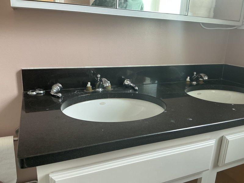 Responded to service call for bathroom plumbing evaluation on double sink vanity. Inspected undermount sink configuration with chrome fixtures and verified proper operation of P-trap drain assembly and supply line connections. All plumbing components found to be in standard working condition with no leaks detected at time of inspection.