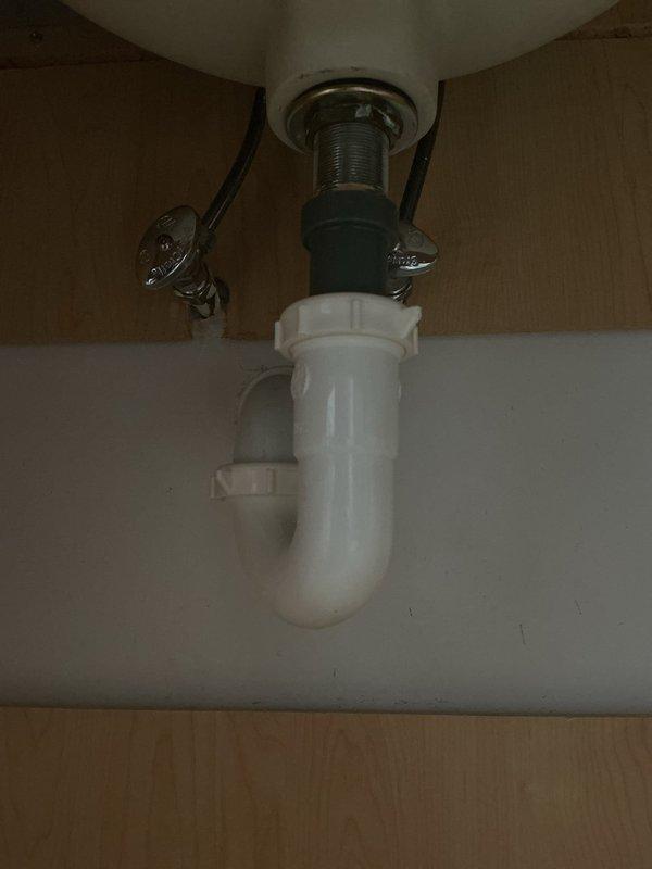 Responded to service call for bathroom plumbing evaluation on double sink vanity. Inspected undermount sink configuration with chrome fixtures and verified proper operation of P-trap drain assembly and supply line connections. All plumbing components found to be in standard working condition with no leaks detected at time of inspection.