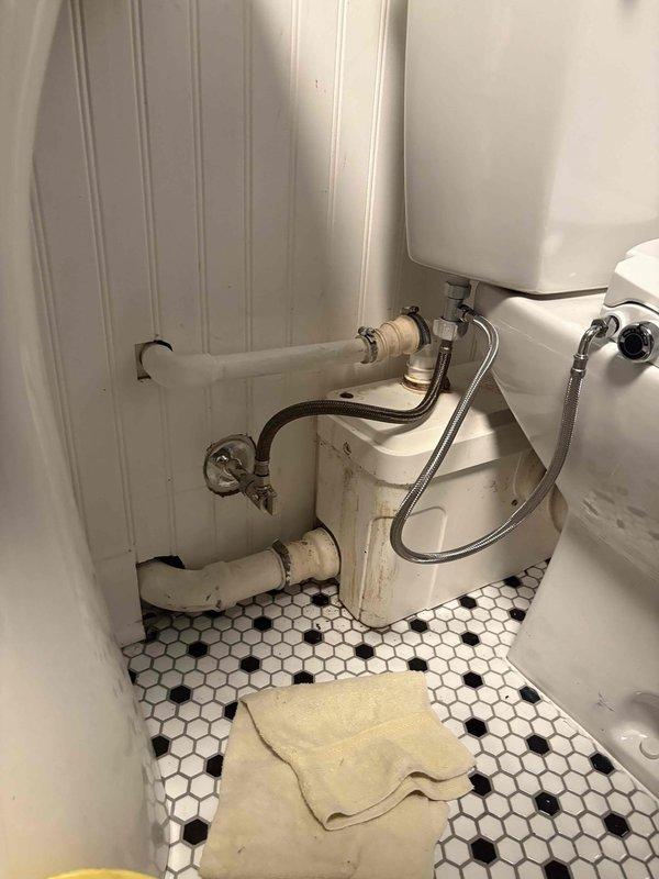 Replaced failed macerating pump system in residential bathroom. Removed and disposed of existing unit after disconnecting all hose clamps and band connections from existing piping. Installed new macerating pump with proper connections and bands to integrate with current plumbing configuration. Reinstalled toilet fixture using new mounting bolts to ensure secure placement. All connections tested and verified operational upon completion.