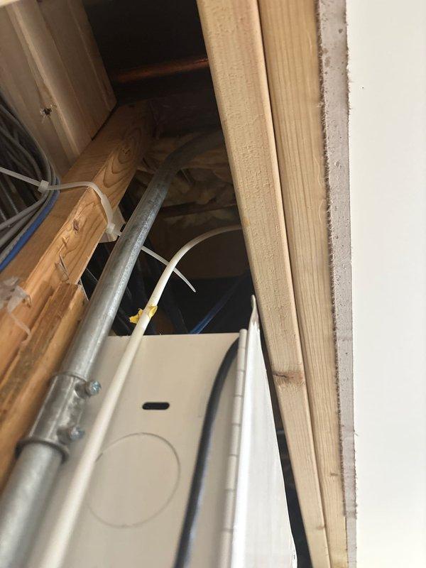 Responded to disconnect refrigerator water line in century-old home where supply line was concealed behind basement ceiling drywall. Located and accessed the copper supply line running through floor joists by opening access point in finished ceiling. Shut off water supply, disconnected refrigerator line connection, and capped the supply line to prevent future water flow. Work required navigating existing electrical wiring and structural framing in confined space to safely complete the disconnection.