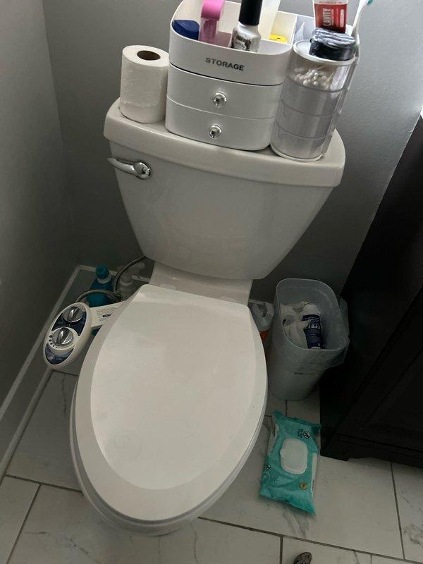 # Plumbing Service - Water Leak

Responded to active water leak in 120-year-old three-flat residential building where water was penetrating from second floor into first floor, causing ongoing damage over a six-day period. Upon arrival, accessed ceiling cavity and attic space to locate source of leak. Inspected extensive copper plumbing system showing significant age-related deterioration, including green patina formation and corrosion on multiple pipe sections. 

Traced leak path through wooden joists and framing members in ceiling space, identifying compromised piping near HVAC components and gray metal ductwork. Examined multiple pipe joints, fittings, and connections throughout the affected area. Documented existing conditions including aged copper pipes with varying degrees of oxidation, exposed wooden structural members with water staining, and insulation materials in proximity to plumbing lines.

Investigated second-floor bathroom directly above affected area, inspecting toilet i