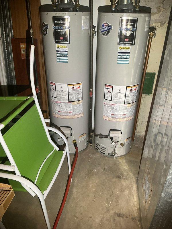 Completed enrollment and payment collection for Silver VIP annual membership covering all water heater and pump system maintenance and service for single-family residence. Membership includes priority dispatching, waived dispatch and emergency fees, discounted VIP pricing on all services, comprehensive annual plumbing system evaluation, water heater flush and maintenance for gas/electric tank or tankless units, and pump and pit inspection with check valve service. Documentation and photos taken of dual water heater installation in basement utility area showing both units with proper labeling, copper supply piping, brass fittings, gas controls, and drain valves in operational condition. Membership renewal processed with continuous coverage transition.