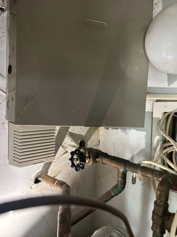 Responded to service call regarding malfunctioning water shut-off valve for condo unit. Upon inspection, confirmed that valve wheel turns freely but fails to stop water flow, indicating internal valve failure. Documented existing plumbing configuration including copper supply lines and valve assembly for estimate preparation.