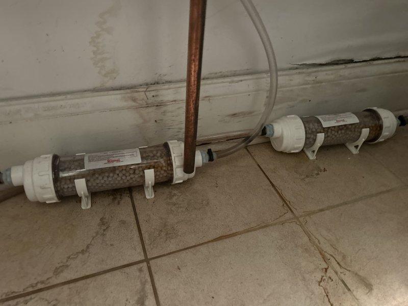 Completed comprehensive VIP maintenance service on two tankless water heaters and associated circulation pumps. Inspected and serviced water filtration system including dual-stage filter housings with mesh cartridges, verified proper mounting and connections along copper supply lines. Examined and tested pump assemblies in crawl space, including flexible coupling connections with red and blue adapters secured with stainless steel hose clamps. Verified all PVC and copper piping connections for proper flow and absence of leaks. Checked electrical connections and sensor wiring throughout the system. All equipment operational and functioning within normal parameters upon completion.