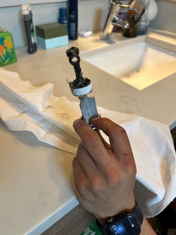 Successfully recovered lost earring from master bathroom drain and cleared both clogged master bathroom sinks that had been blocked for several months. Disassembled P-trap assemblies, removed accumulated debris and hair buildup, and retrieved jewelry item intact. Replaced kitchen under-sink water filter cartridge and assessed poorly configured filtration system installation. Due to inadequate clearance and tight spacing in cabinet, recommended future service to relocate filter housing for improved accessibility and simplified maintenance.