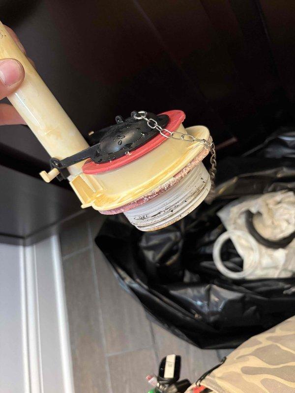 Responded to a toilet tank that was periodically refilling every 10-15 minutes following recent installation of aftermarket Korky flapper and fill valve components. Upon inspection, diagnosed a faulty flush valve seal causing a slow leak from the tank into the bowl, triggering the fill valve to activate repeatedly. Removed and replaced the compromised flush valve assembly, which showed significant mineral buildup and deterioration of the sealing surfaces. Tested the system to confirm proper operation with no phantom flushing or continuous running.