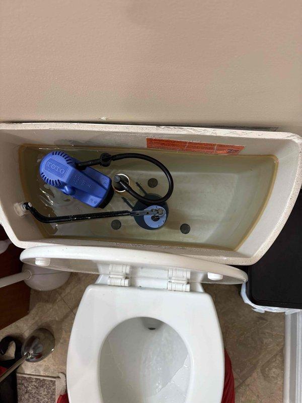 Responded to service call for toilet that would not flush due to constantly running water and tank failing to fill properly. Upon inspection, found faulty flush valve assembly and compromised flapper mechanism preventing proper tank fill cycle. Removed toilet tank lid and diagnosed malfunctioning Fluidmaster-style fill valve system with defective flapper chain connection. Repaired toilet flush system by replacing worn components, adjusted float mechanism, and verified proper water supply line connection. Tested flush cycle multiple times to ensure tank fills completely and water flow stops appropriately, restoring full toilet functionality.