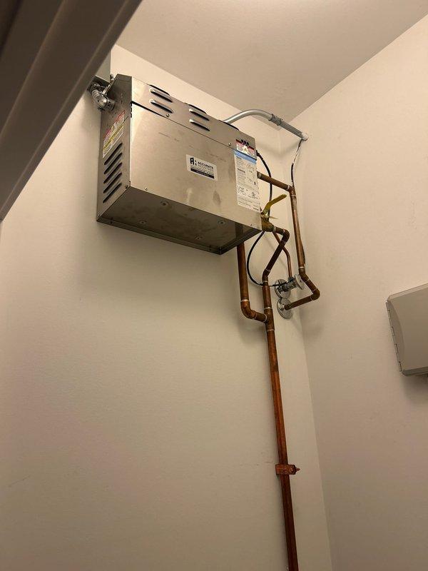 Conducted on-site evaluation of existing tankless water heater system to prepare comprehensive replacement estimates for Navien tankless water heater installation. Assessed current wall-mounted unit configuration, including internal plumbing connections, copper supply lines with isolation valves, electrical connections, and venting requirements. Documented existing installation specifications, pipe routing, clearances, and mounting location to ensure accurate equipment sizing and installation planning for proposed Navien system upgrade.