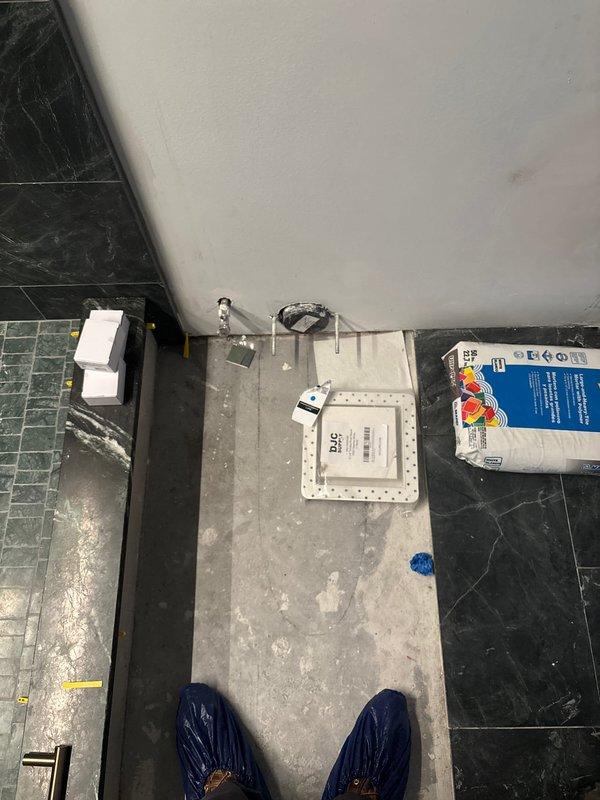 Completed installation of new toilet fixture in commercial or residential bathroom space. Prepared concrete pad base for proper fixture mounting, positioned new toilet unit with wax ring seal and closet flange connection, and secured all mounting hardware to ensure stable installation. Verified proper drainage function and conducted final inspection of completed work.