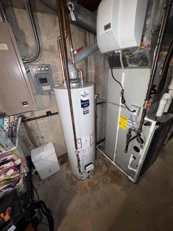 Conducted on-site assessment of existing A.O. Smith 40-gallon atmospheric vent gas water heater in basement mechanical room. Documented current installation including copper supply and discharge piping connections, venting configuration, and proximity to electrical panel and HVAC equipment. Photographed unit specifications and serial number for estimate preparation. Customer requesting pricing for potential future replacement, no immediate service work authorized at this time.