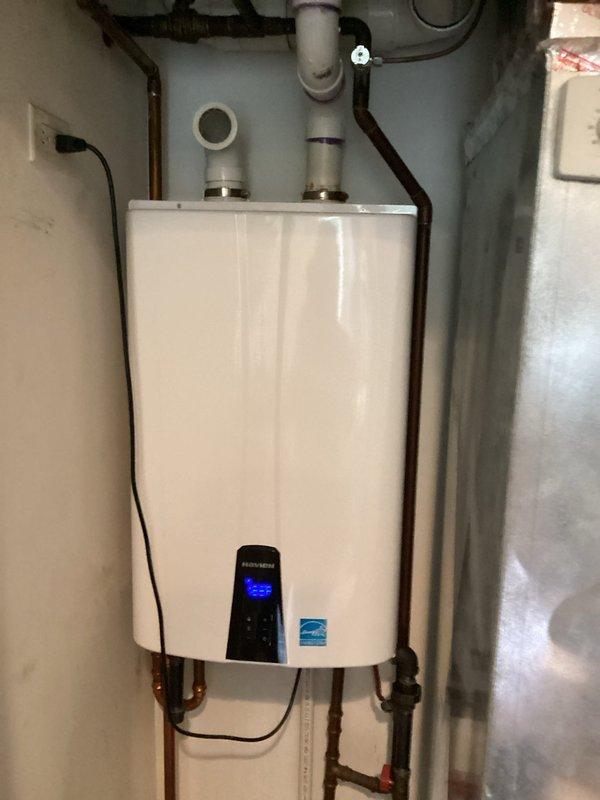 Completed VIP maintenance service on tankless water heater system. Performed comprehensive inspection of unit, including verification of digital display functionality, temperature settings, and overall operational status. Inspected all water supply connections, copper piping, gas line connections, and PVC venting system for proper installation and potential leaks. Removed and cleaned inlet mesh filter screen, which showed significant accumulation of sediment and debris that could restrict water flow and reduce system efficiency. Documented equipment condition through photography showing unit installation and filter condition. All components found to be properly mounted and secured, with Energy Star certified unit operating within normal parameters.