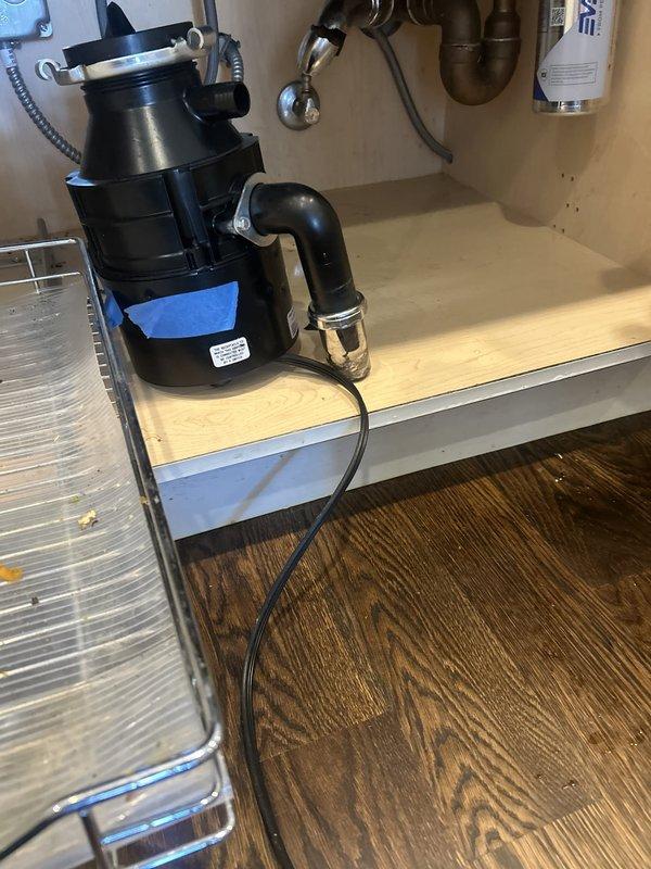 Responded to a kitchen sink leak caused by a failed P-trap assembly connected to the garbage disposal unit. Removed the damaged S-shaped drain pipe, inspected the disposal connection and cabinet plumbing system, and installed a new P-trap assembly with proper sealing. Verified all connections were secure, tested the system for leaks, and confirmed proper drainage function through both the sink and disposal unit.