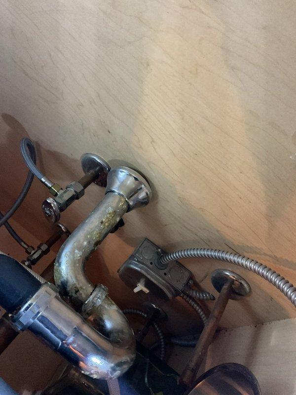 Replaced corroded chrome P-trap assembly under sink due to significant mineral buildup and deterioration of existing fixture. Installed new chrome-plated P-trap with proper slip-joint connections to restore proper drainage and prevent future leaks.