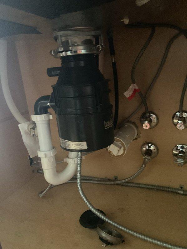 Responded to service call for inoperative garbage disposal unit. Upon inspection, found InSinkErator Badger 500-2 model disposal jammed due to foreign object obstruction. Removed obstruction from grinding chamber, tested motor function and reset mechanisms, and verified proper operation of disposal unit. Confirmed drainage system and P-trap connections secure with no leaks. Unit restored to full working condition.