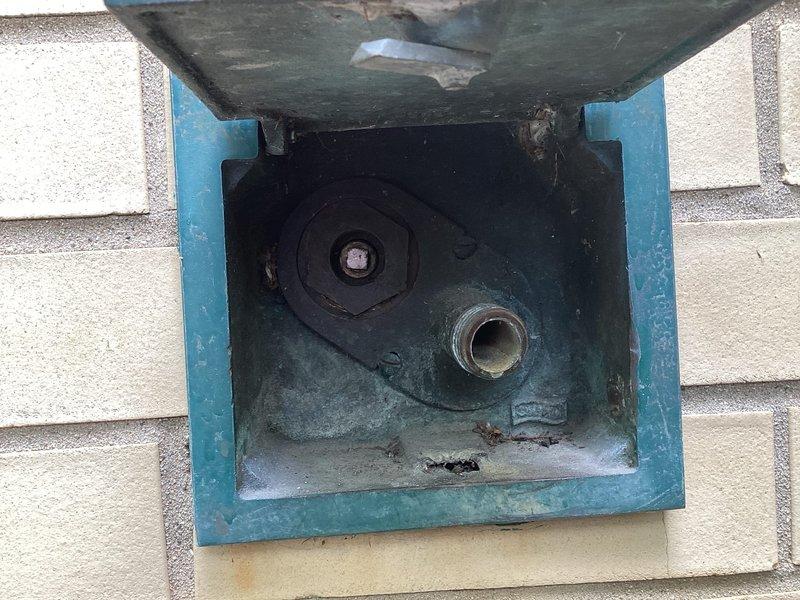 Replaced defective ball valve on exterior water line accessed through recessed utility box in exterior wall. Restored proper water flow control and verified system operation upon completion.