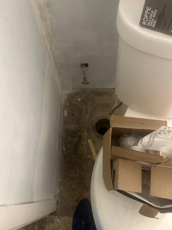 # Drain and Sewer Estimate - Plumbing Relocation Assessment

Conducted a comprehensive site evaluation for relocating sink plumbing from one side of the residence to another. Assessed existing plumbing infrastructure, including water supply lines and drainage connections visible behind the toilet area. Documented current conditions showing significant floor deterioration, water damage, and potential mold growth in the bathroom space, which will need to be addressed during the relocation process. Evaluated wall-mounted shut-off valves and existing supply line configurations to determine optimal routing for the proposed sink relocation. Photographed plumbing fixtures and new installation materials on-site to develop accurate scope of work for the relocation project.