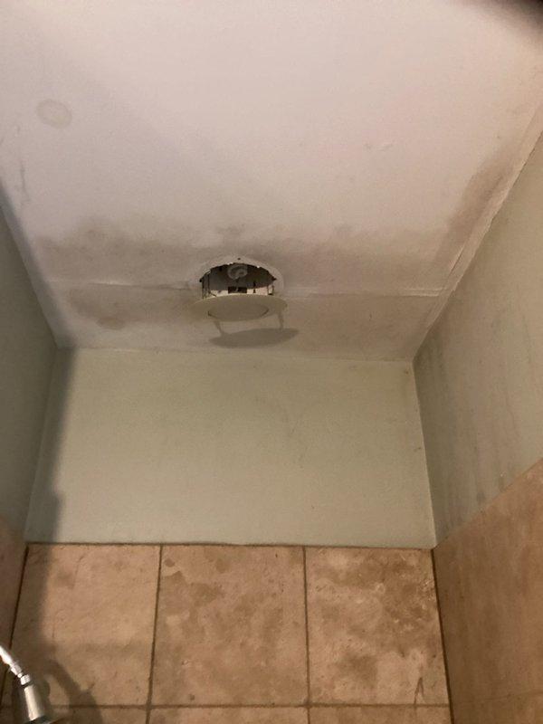 Responded to a multi-unit plumbing emergency where a failed lead seal in the upper unit shower was causing water intrusion into the lower unit shower below. Accessed the affected area using a 6-foot ladder and cut out the compromised section of 2-inch drain pipe and trap assembly. Removed the deteriorated lead seal, reinstalled the shower trap with a new rubber seal, and secured all piping with appropriate hangers to prevent future movement. Conducted thorough water testing to verify the repair eliminated the leak between units, with cosmetic ceiling and wall repairs in the lower unit to be completed by property owner.