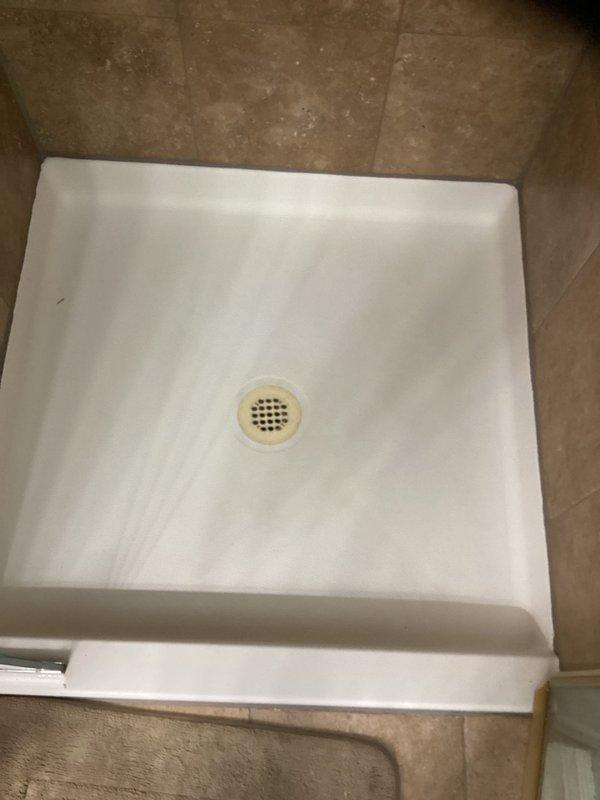 Responded to a multi-unit plumbing emergency where a failed lead seal in the upper unit shower was causing water intrusion into the lower unit shower below. Accessed the affected area using a 6-foot ladder and cut out the compromised section of 2-inch drain pipe and trap assembly. Removed the deteriorated lead seal, reinstalled the shower trap with a new rubber seal, and secured all piping with appropriate hangers to prevent future movement. Conducted thorough water testing to verify the repair eliminated the leak between units, with cosmetic ceiling and wall repairs in the lower unit to be completed by property owner.