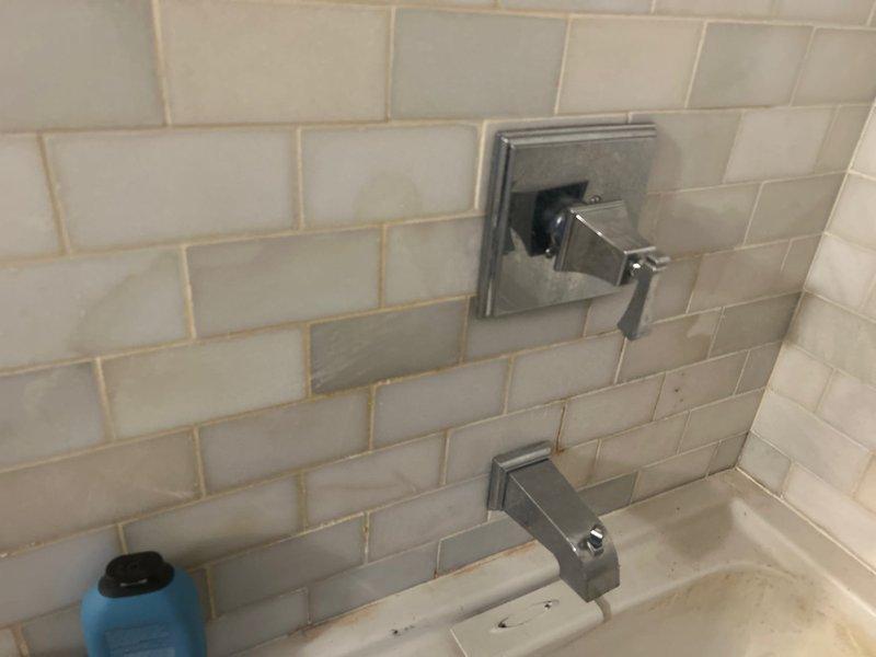 Responded to service call for toilet installation and leak investigation. Upon arrival, assessed bathroom with active leak from upper level bathroom penetrating into lower level bathroom ceiling. Inspected existing bathtub fixtures and surrounding tile work for source of water intrusion. Examined plumbing connections, supply lines, and drain assembly at toilet base. Documented existing conditions including bathroom layout, tile surfaces, and fixture placement. Customer has two toilets requiring installation and leak repair work pending approval to proceed with recommended repairs.