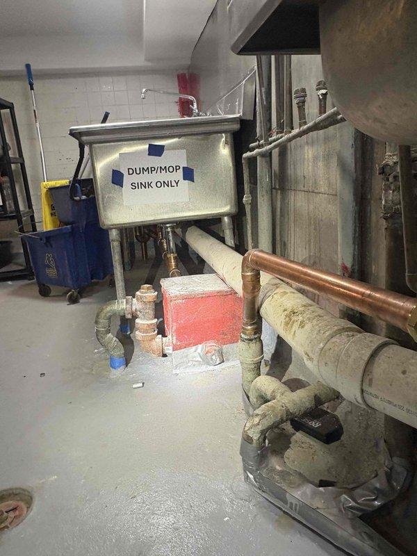 Conducted comprehensive plumbing assessment in basement utility area to evaluate deteriorated PVC piping system requiring replacement. Documented existing conditions of main drainage lines, utility sink connections, and mechanical room plumbing infrastructure through photographic evidence. Prepared detailed estimate for large-diameter PVC pipe replacement, including evaluation of copper supply lines, drain connections, and integration with existing water heater and utility sink systems in the mechanical space.