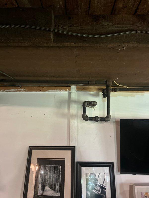 Conducted comprehensive plumbing estimate and inspection of exposed piping systems in basement and crawl space areas. Documented existing pipe conditions including visible corrosion and oxidation on older metal trap configuration, assessed structural exposure of plumbing infrastructure, and photographed utility connections and mounting fixtures for piping estimate proposal.