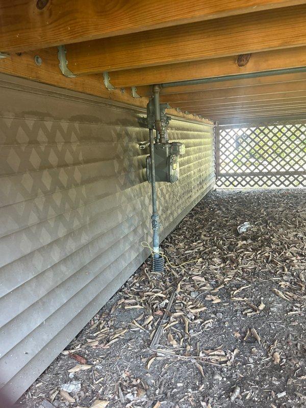 Conducted comprehensive plumbing estimate and inspection of exposed piping systems in basement and crawl space areas. Documented existing pipe conditions including visible corrosion and oxidation on older metal trap configuration, assessed structural exposure of plumbing infrastructure, and photographed utility connections and mounting fixtures for piping estimate proposal.