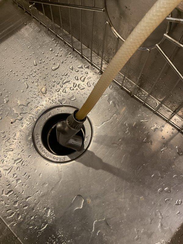 Responded to service call for kitchen sink faucet assembly. Upon inspection, found the spray nozzle required disassembly and servicing. Removed the chrome spray nozzle head from the mounting assembly and detached the white mounting bracket from the plumbing connection beneath the sink. Cleaned and inspected all components for wear, mineral buildup, and proper function. Addressed water flow issues and verified spray pattern functionality. Reassembled faucet components with proper seating of mounting hardware and tested for leaks. System restored to full operational status with proper water pressure and spray function confirmed.