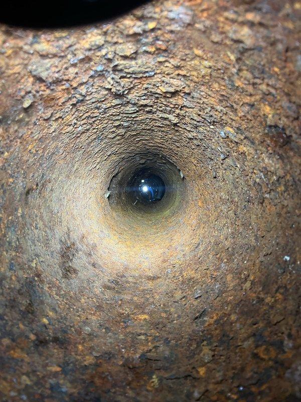 Performed video inspection of main sewer line and identified offset/sheared clay tile pipe section causing structural compromise to the system. Documented extensive corrosion and deterioration within the line through photographic evidence. Recommended excavation and repair of the damaged clay tile section to prevent future backups and potential system failure. Advised follow-up camera inspection after repairs are completed to verify integrity of remaining pipe sections and ensure no additional defects exist downstream or upstream of the repair area.