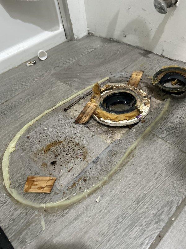 Responded to complaint of persistent sewage odor in bathroom of century-old residence. Upon inspection, removed toilet to expose severely corroded and deteriorated toilet flange assembly. Flange exhibited extensive rust damage compromising the seal integrity, which was determined to be the source of sewer gas infiltration into the living space. Removed failed flange hardware, prepared subfloor surface, and installed new corrosion-resistant toilet flange with proper sealing to restore sanitary drainage system integrity and eliminate odor issue.
