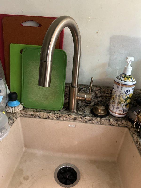 Replaced cracked galvanized waste arm drain pipe connected to main vertical stack with new PVC drainage system for kitchen sink and garbage disposal. Modified cabinet base to access vertical stack behind cabinetry, then installed new drain pipes and P-traps for both fixtures. All connections tested and verified leak-free upon completion.