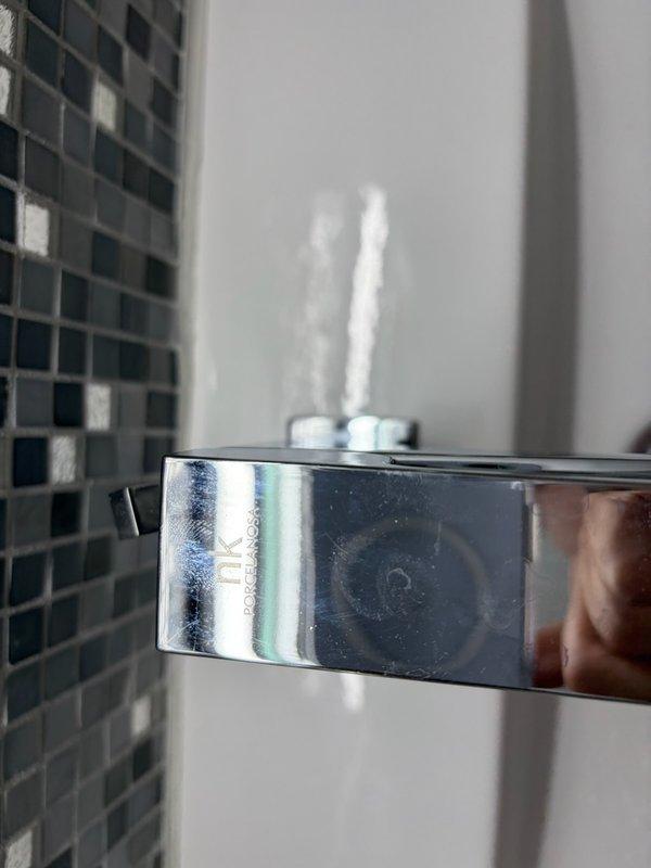 Completed bathroom faucet replacement in residential unit, removing existing 40-year-old fixture and installing new single-handle chrome faucet with contemporary geometric design on white ceramic sink basin. Installation included proper mounting to sink deck, connection to existing supply lines, verification of water flow and drainage function, and confirmation of no leaks at all connection points.