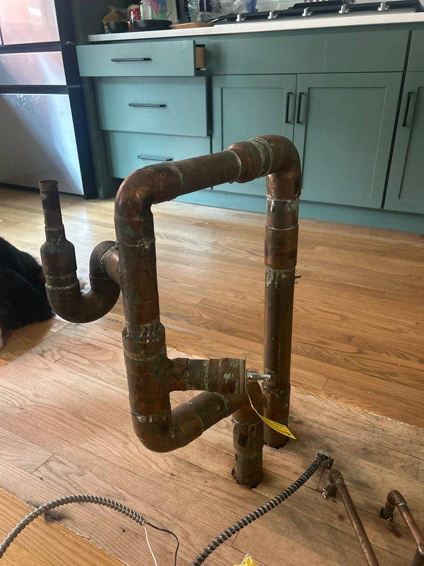 Responded to kitchen water leak originating from dishwasher connection. Performed comprehensive plumbing reconstruction for insurance documentation purposes. Removed existing aged copper water supply lines showing significant oxidation and corrosion. Disconnected and removed old kitchen faucet assembly with brass cross-handle fixtures and deteriorated P-trap drain assembly from double basin sink configuration.

Installed 3 feet of new copper water supply line to replace compromised piping. Completed kitchen faucet installation with new supply connections. Reset double basin sink with proper sealing and alignment. Reassembled and reset P-trap drain assembly ensuring proper trap depth and secure connections. Reconnected dishwasher water supply and drain lines with leak-free connections. Reset garbage disposal unit with proper mounting and electrical connections verified.

Documented existing water damage to hardwood flooring showing staining patterns consistent with prolonged leak exposu