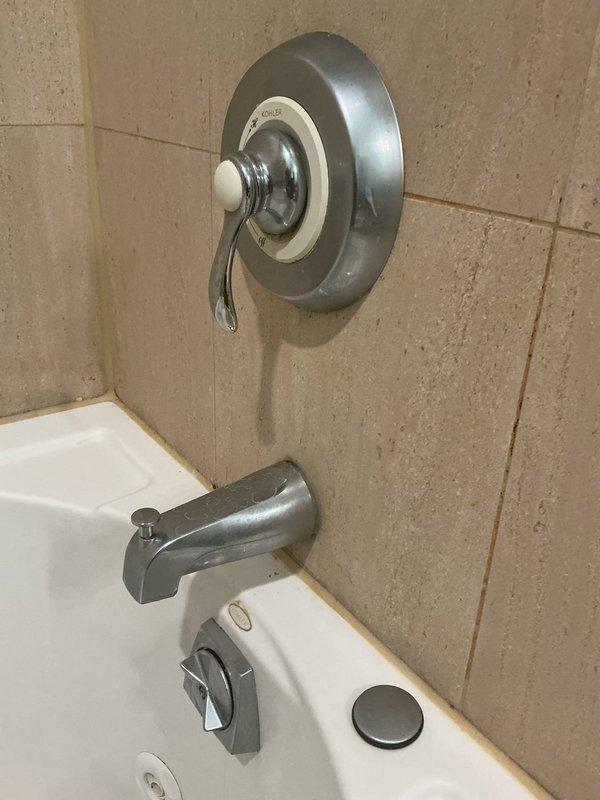 Responded to service call for malfunctioning tub spout diverter mechanism. Upon inspection, found the pull-up diverter pin on the chrome tub spout was disconnected and no longer engaging to redirect water flow from tub spout to shower head. Assessed the existing fixture assembly including the single-handle shower valve and tub spout mounted on tiled wall. Provided estimate for diverter repair or complete tub spout replacement to restore proper water flow switching functionality between tub and shower modes.