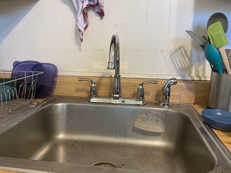 Completed kitchen faucet inspection and assessment for aging fixture replacement. Customer's existing chrome pull-down faucet with high-arc spout and dual handles showed signs of wear consistent with extended use, prompting evaluation for full fixture replacement to restore optimal functionality and prevent potential leaks or operational failures.