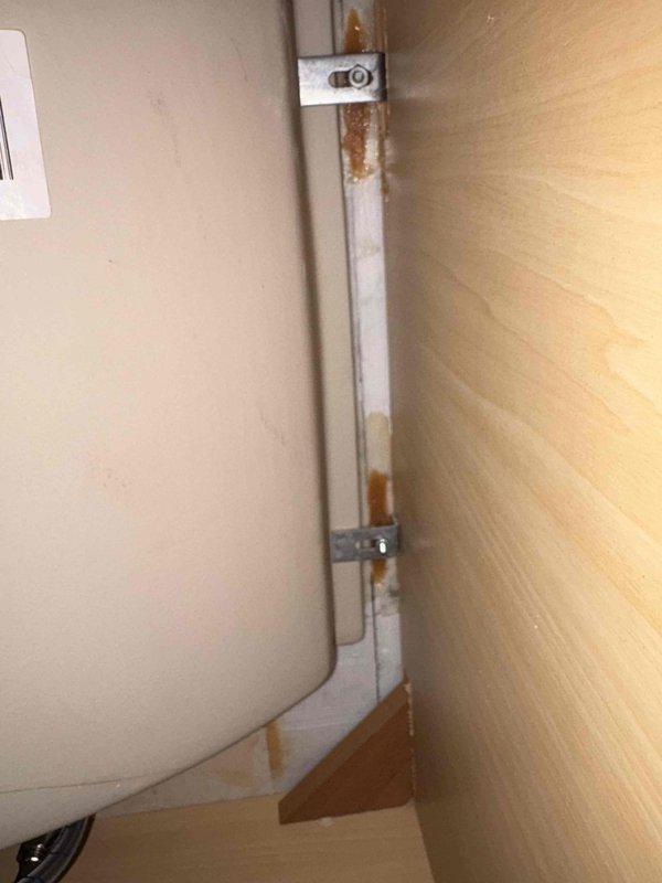 Conducted comprehensive plumbing assessment at 40-year-old residential property requiring fixture replacements and repairs. Evaluated kitchen faucet and cracked sink basin for replacement specifications, inspected bathroom shower thermostatic control valve for heat regulation malfunction, and documented existing plumbing fixtures including matte black shower system with handheld and fixed components. Property access coordinated via phone call due to gated entry, with photographic documentation completed of water heater installation area showing aged mounting hardware with corrosion present, and full bathroom shower/tub assembly featuring subway tile surround and multi-handle temperature control system requiring repair assessment.